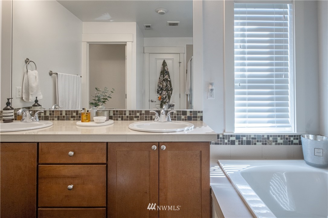 21807 38th Drive Southeast Bothell, WA 98021 - Photo 19 of 30 a bathroom with a tub sink and mirror