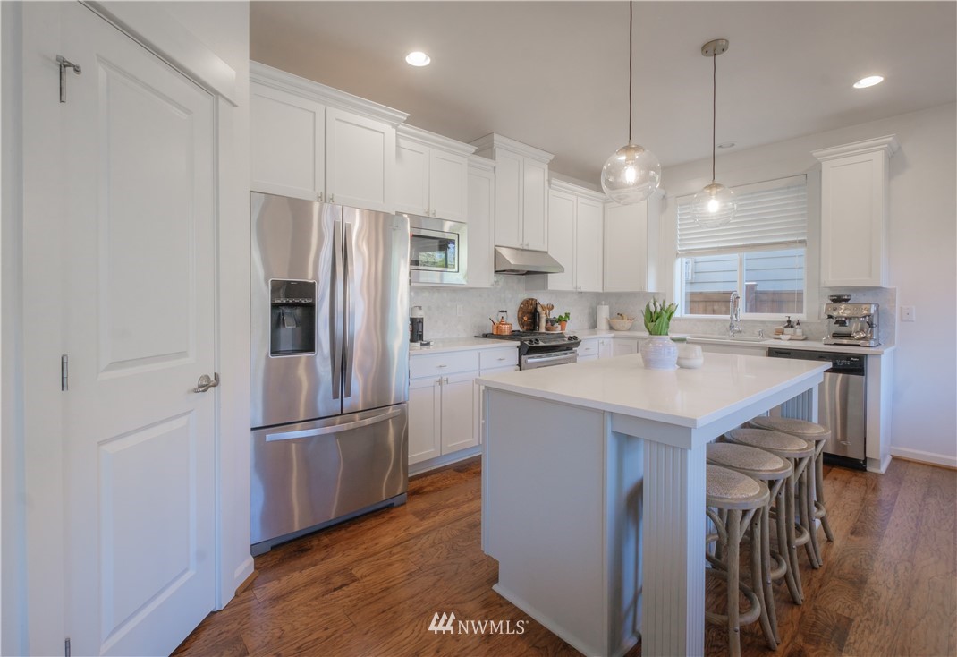 21807 38th Drive Southeast Bothell, WA 98021 - Photo 8 of 30 a kitchen with kitchen island a sink stainless steel appliances and cabinets