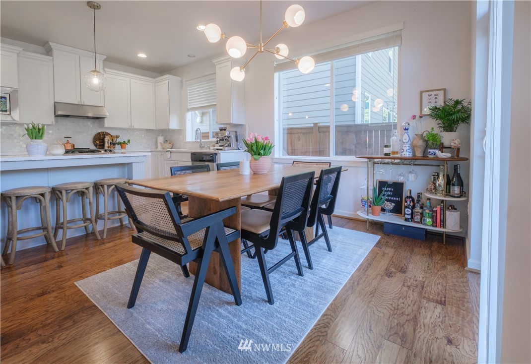 21807 38th Drive Southeast Bothell, WA 98021 - Photo 10 of 30 a view of a dining room with furniture and wooden floor