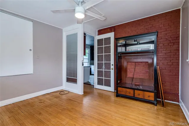 a view of a livingroom with wooden floor and window