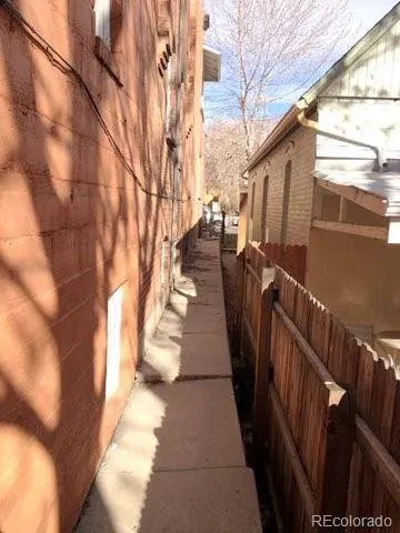 a view of a pathway with a wrought fence