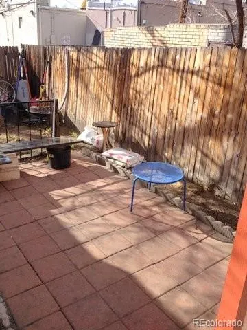 a view of a patio with a table and chairs