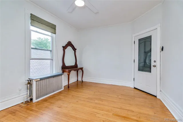 a view of a room with wooden floor and windows