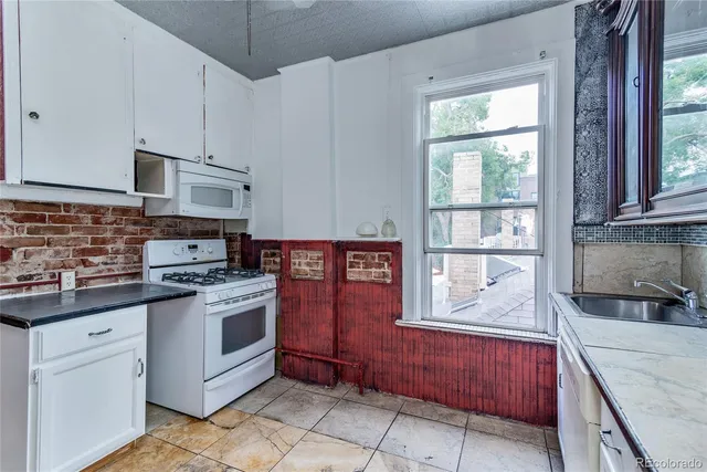 a kitchen with stainless steel appliances granite countertop a stove and a sink