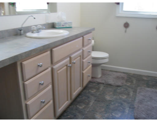 54 Groton Road Shirley, MA 01464 - Photo 15 of 18 a bathroom with a granite countertop sink a toilet and a mirror