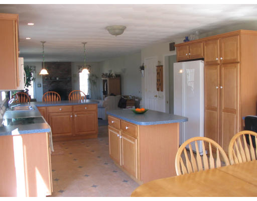 54 Groton Road Shirley, MA 01464 - Photo 6 of 18 a kitchen with stainless steel appliances kitchen island granite countertop a refrigerator and a sink