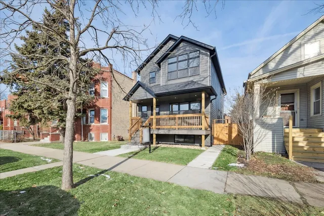 a front view of a house with a yard table and chairs