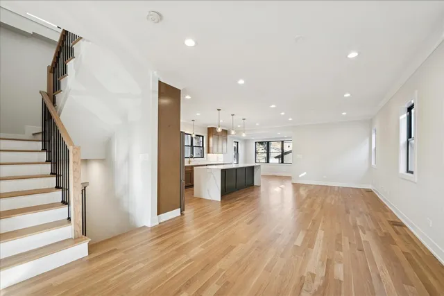 a view of a kitchen with wooden floor and a kitchen
