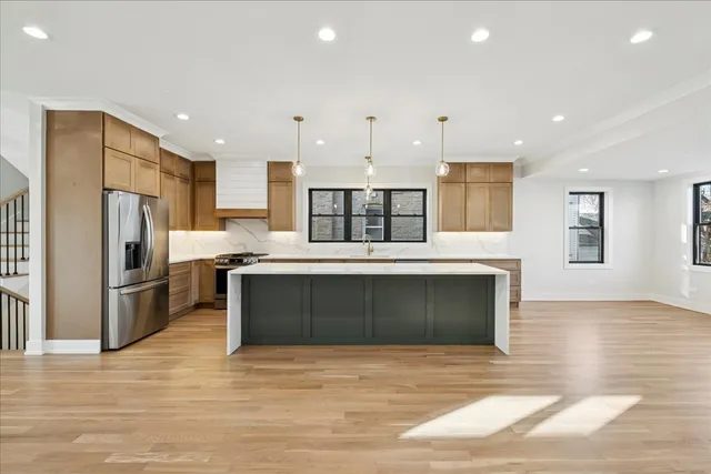a kitchen with a refrigerator and a sink