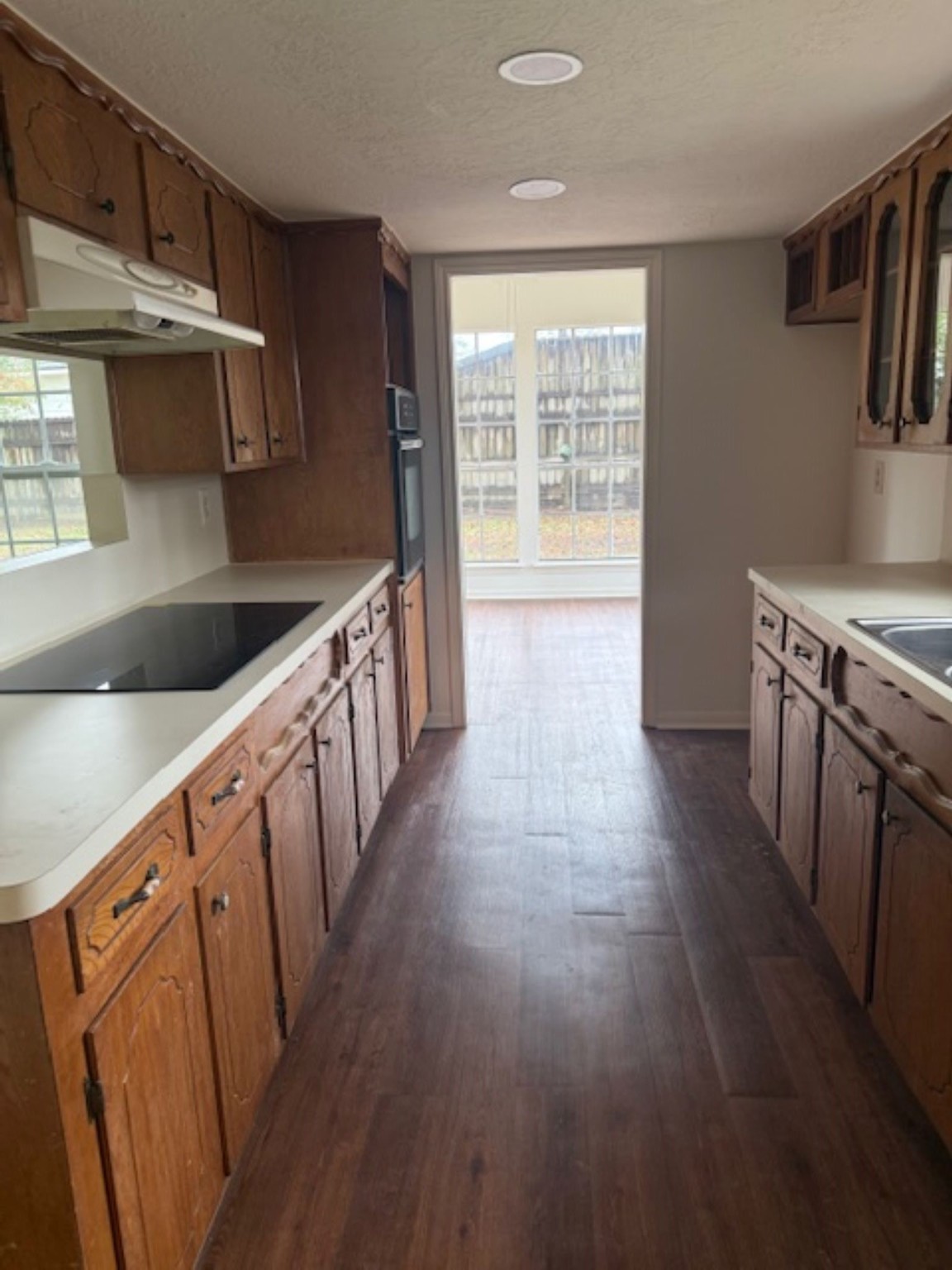 19103 Shay Lane Humble, TX 77346 - Photo 16 of 18 a kitchen with wooden floors and wooden cabinets