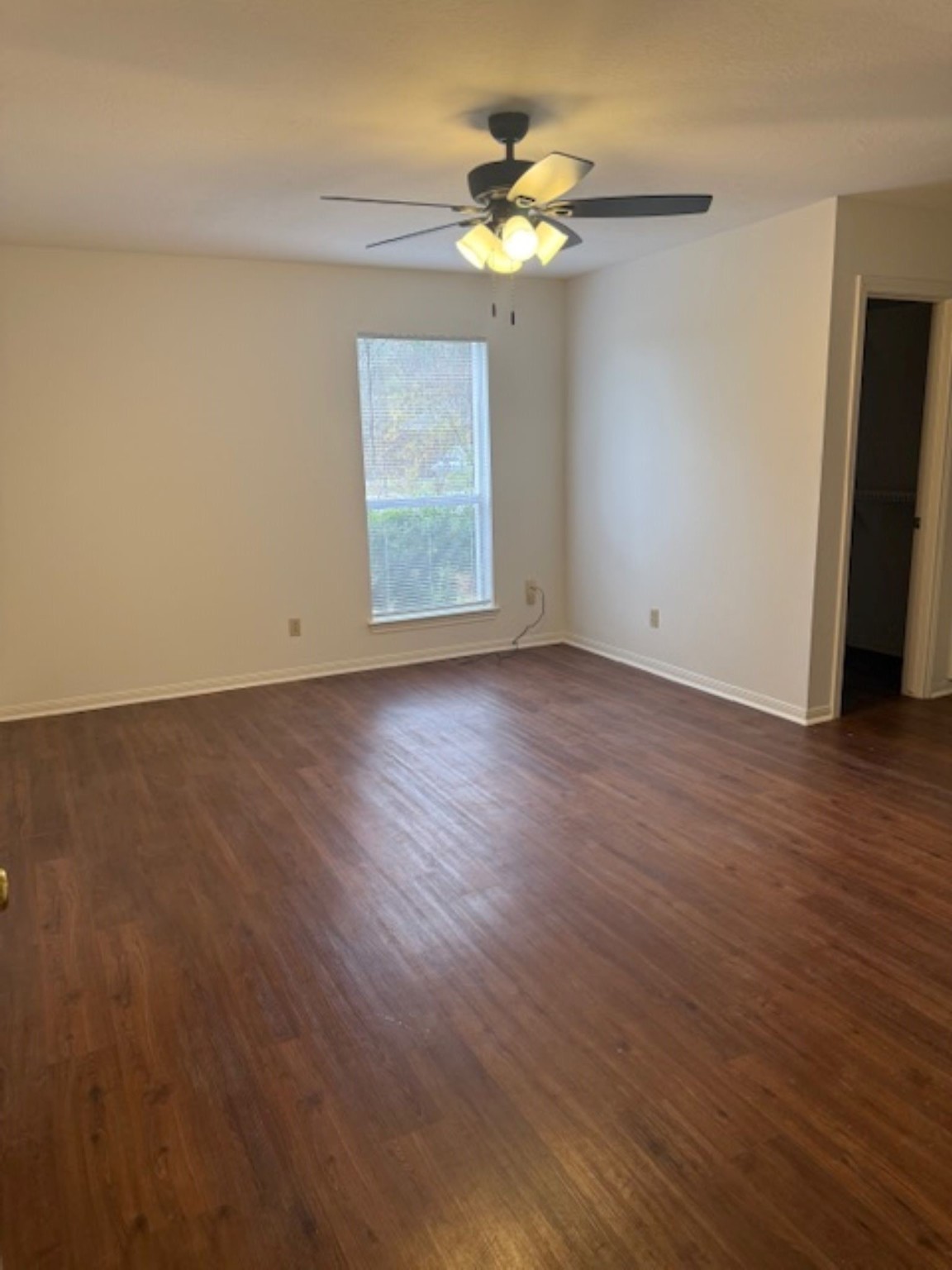 19103 Shay Lane Humble, TX 77346 - Photo 9 of 18 an empty room with wooden floor chandelier fan and windows
