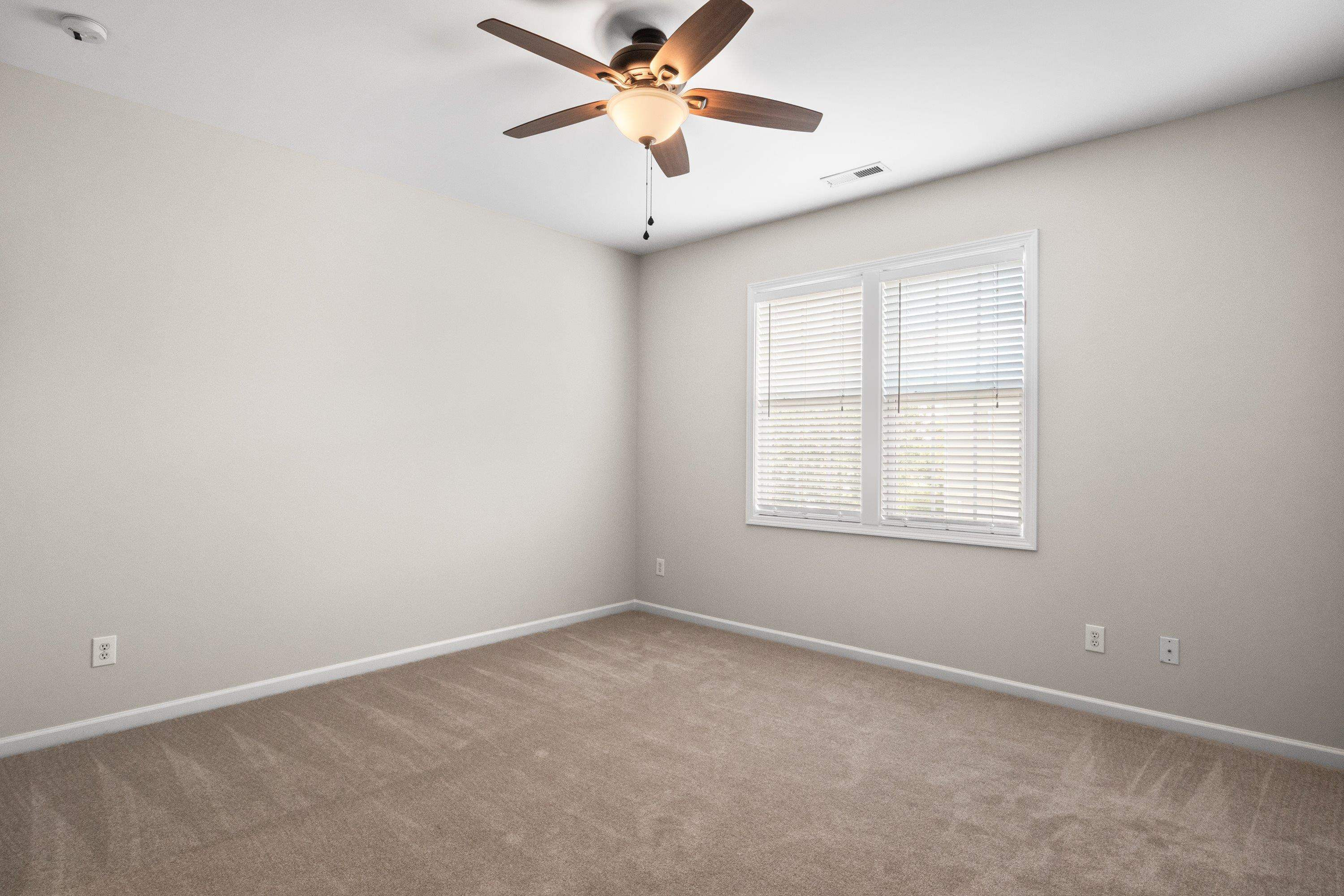 1369 Still Monument Way Raleigh, NC 27603 - Photo 30 of 46 an empty room with a window and a fan