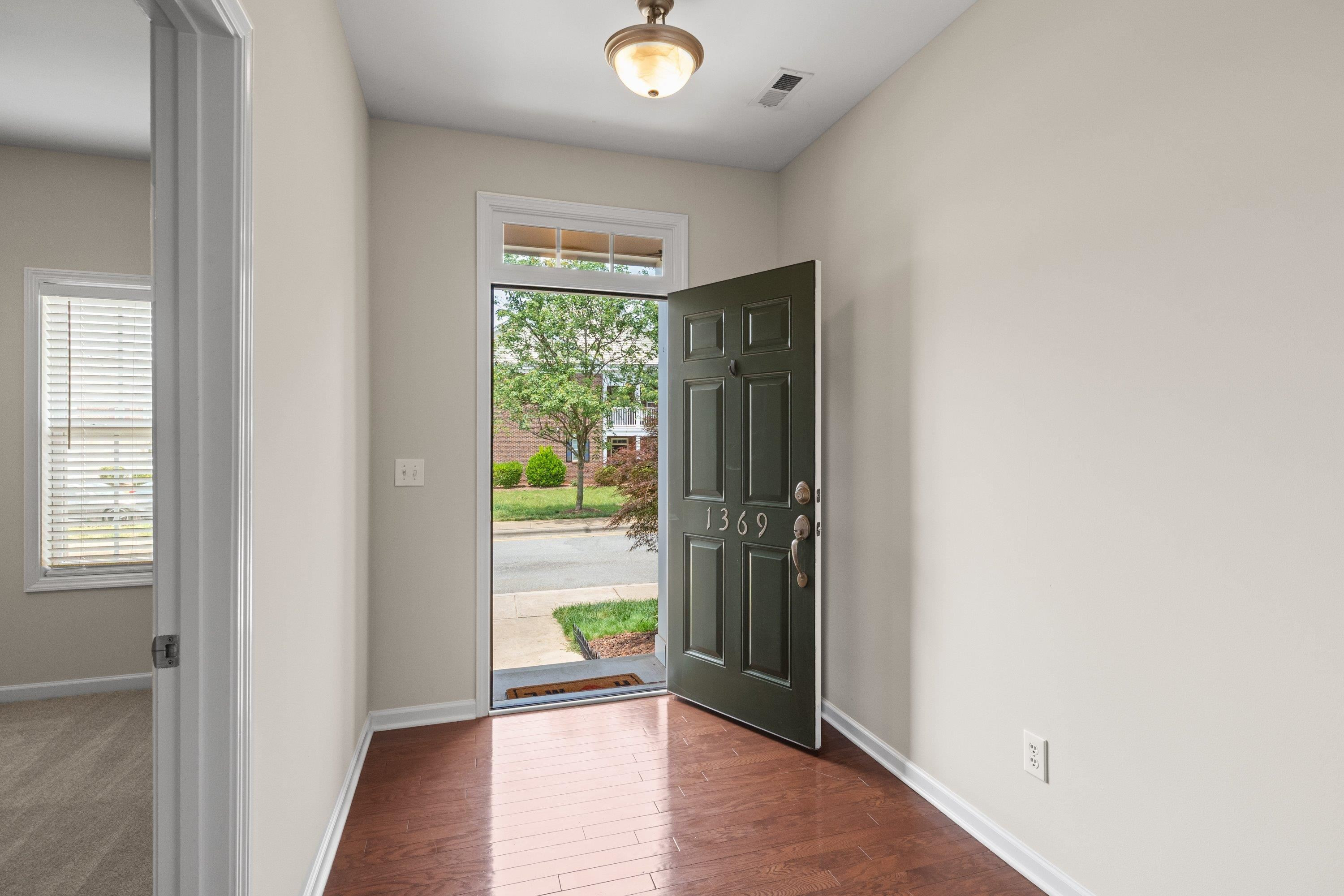 1369 Still Monument Way Raleigh, NC 27603 - Photo 4 of 46 an empty room with window and wooden floor