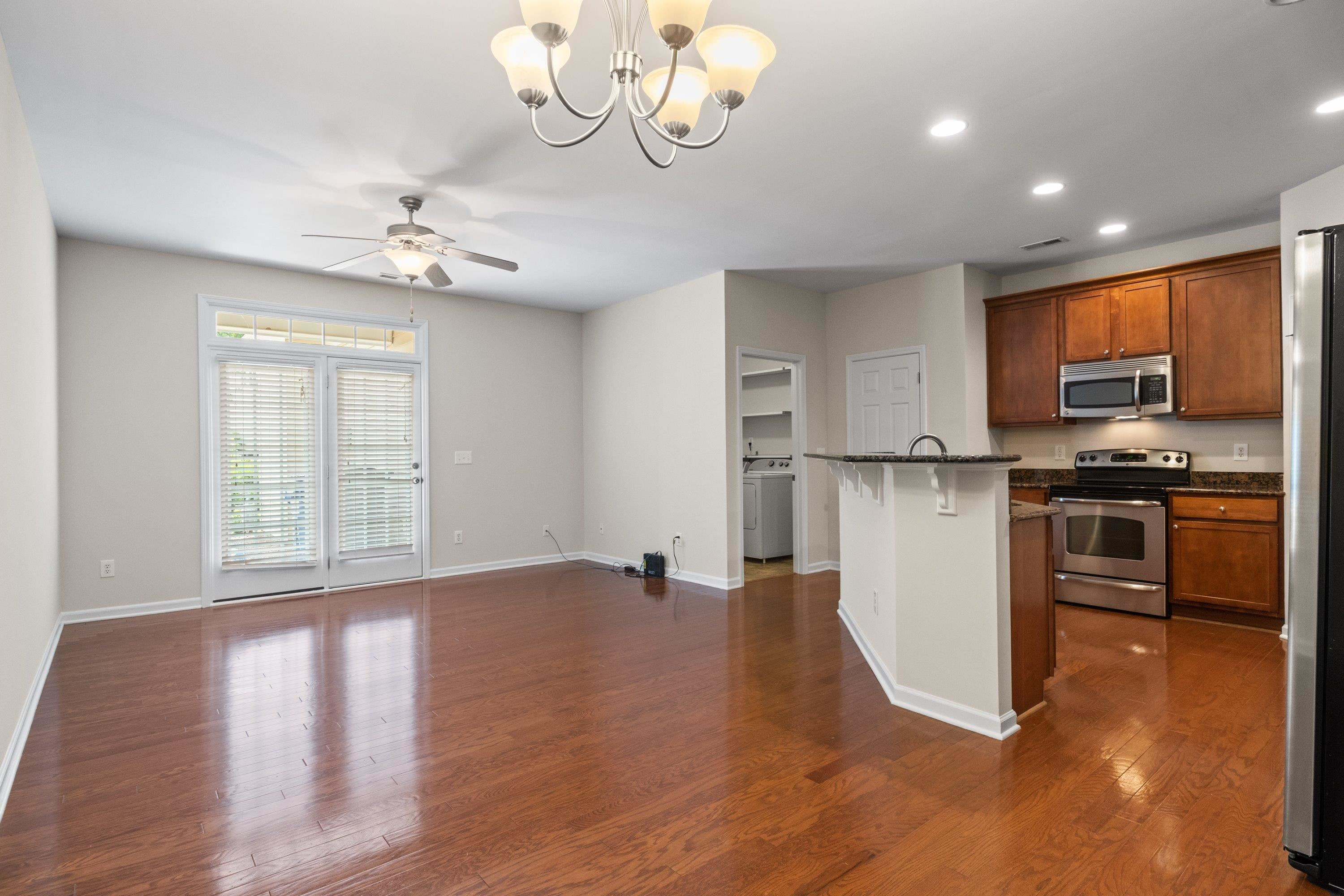 1369 Still Monument Way Raleigh, NC 27603 - Photo 6 of 46 a view of a kitchen with furniture stainless steel appliances and wooden floor