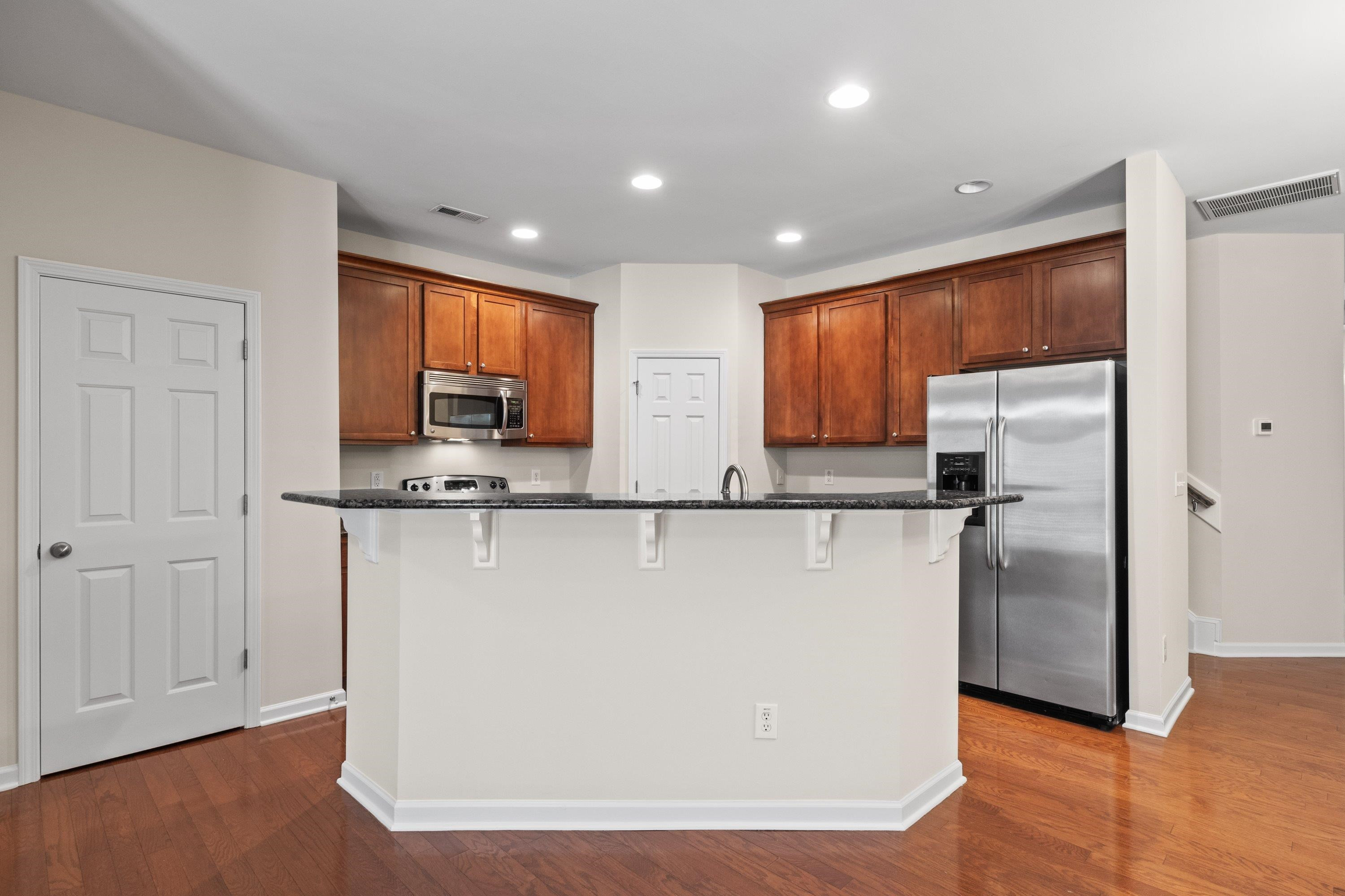 1369 Still Monument Way Raleigh, NC 27603 - Photo 10 of 46 a view of kitchen with stainless steel appliances granite countertop refrigerator sink and cabinets