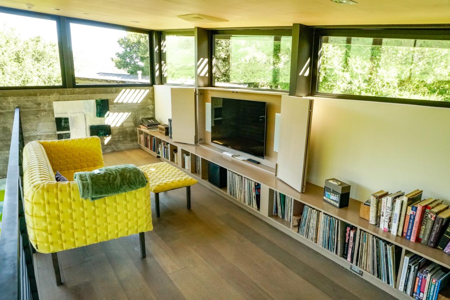 1 Goodrich Trail Carmel, CA 93923 - Photo 21 of 50 a living room with couches bookshelf and a flat screen tv