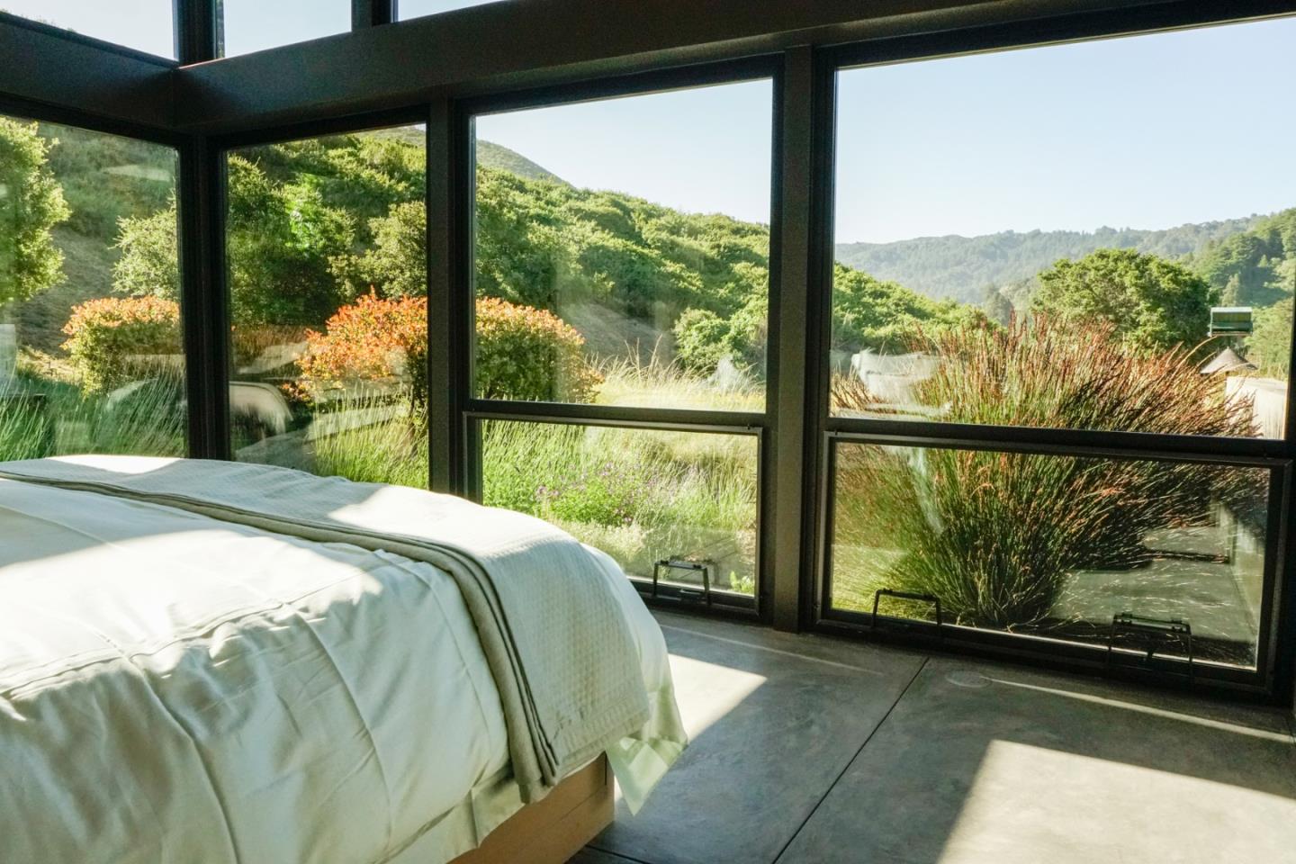 1 Goodrich Trail Carmel, CA 93923 - Photo 23 of 50 a bed sitting in a bedroom next to a large window