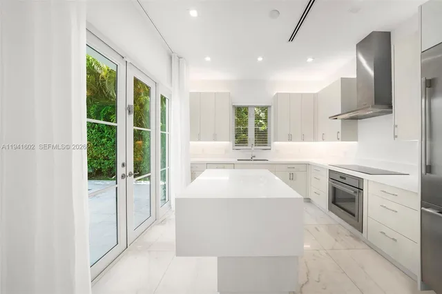 a view of an empty room with a window and potted plants