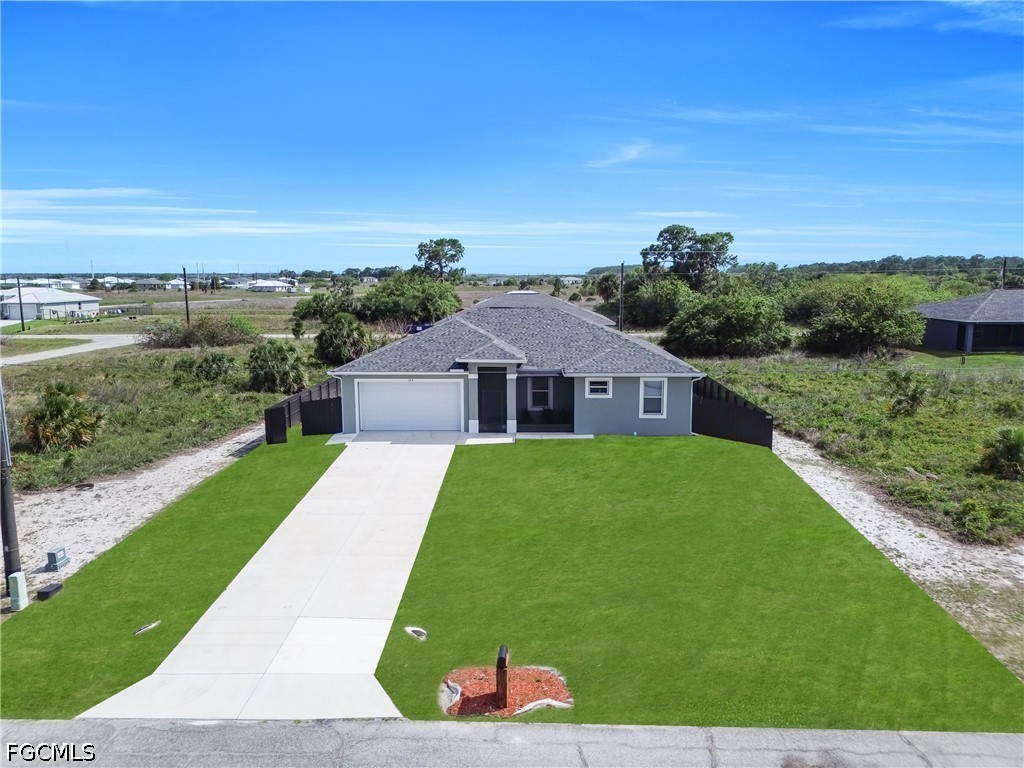 384 Neighborly Road LaBelle, FL 33935 - Photo 45 of 45 a front view of a house with a yard