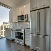 a kitchen with stainless steel appliances a refrigerator sink and microwave