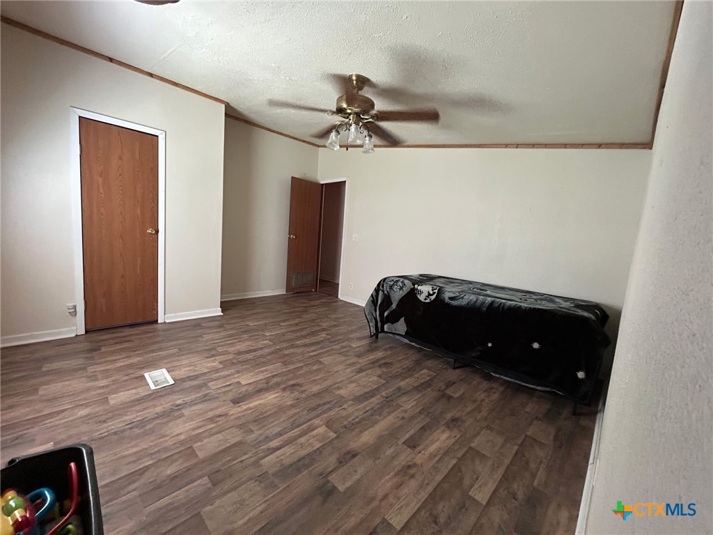 850 Blakely Road Gatesville, TX 76528 - Photo 29 of 32 a room with a bed and a ceiling fan