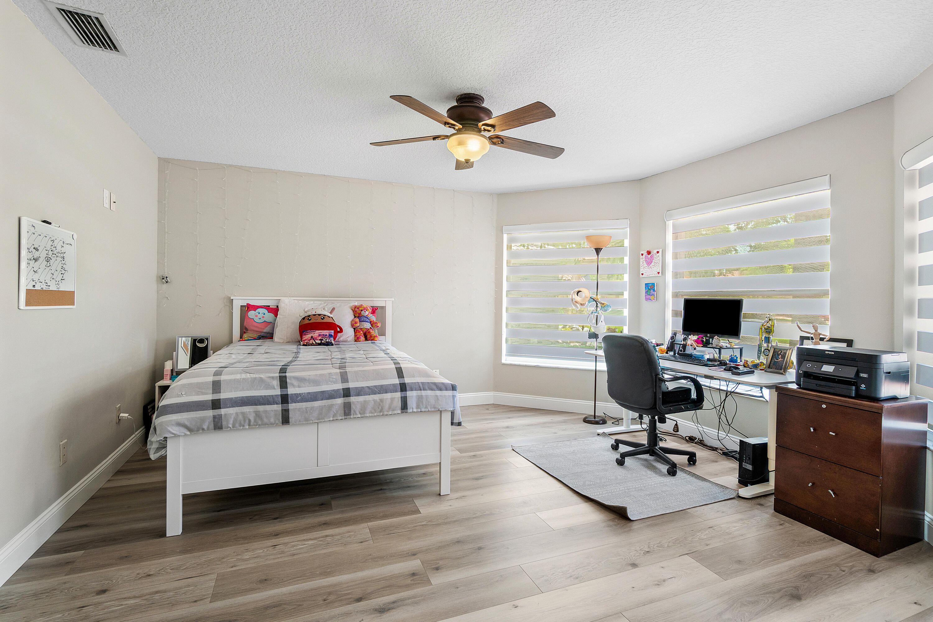 10560 Plainview Circle Boca Raton, FL 33498 - Photo 17 of 45 a bedroom with a bed and wooden floor