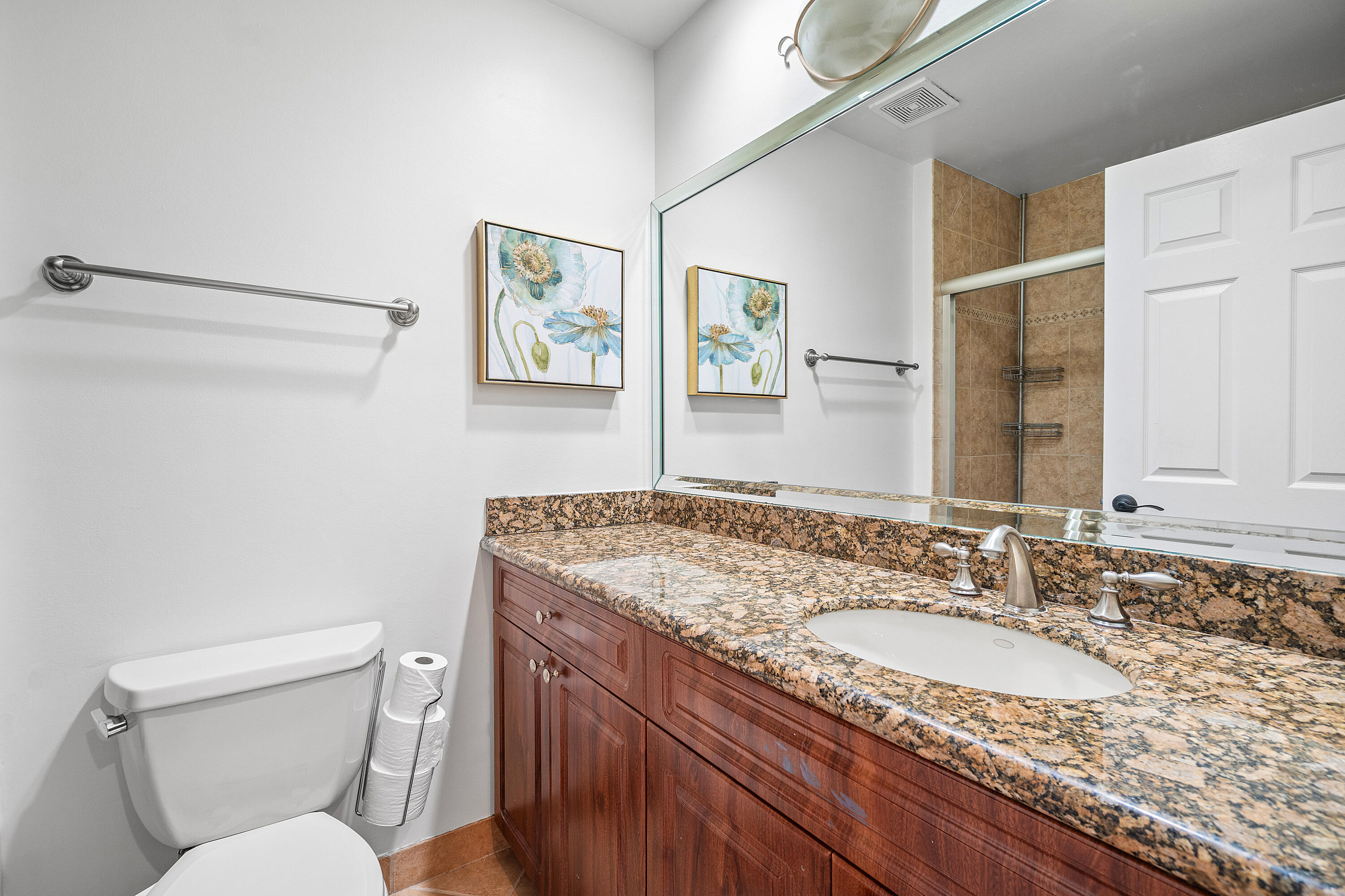 10560 Plainview Circle Boca Raton, FL 33498 - Photo 19 of 45 a bathroom with a granite countertop toilet sink and mirror