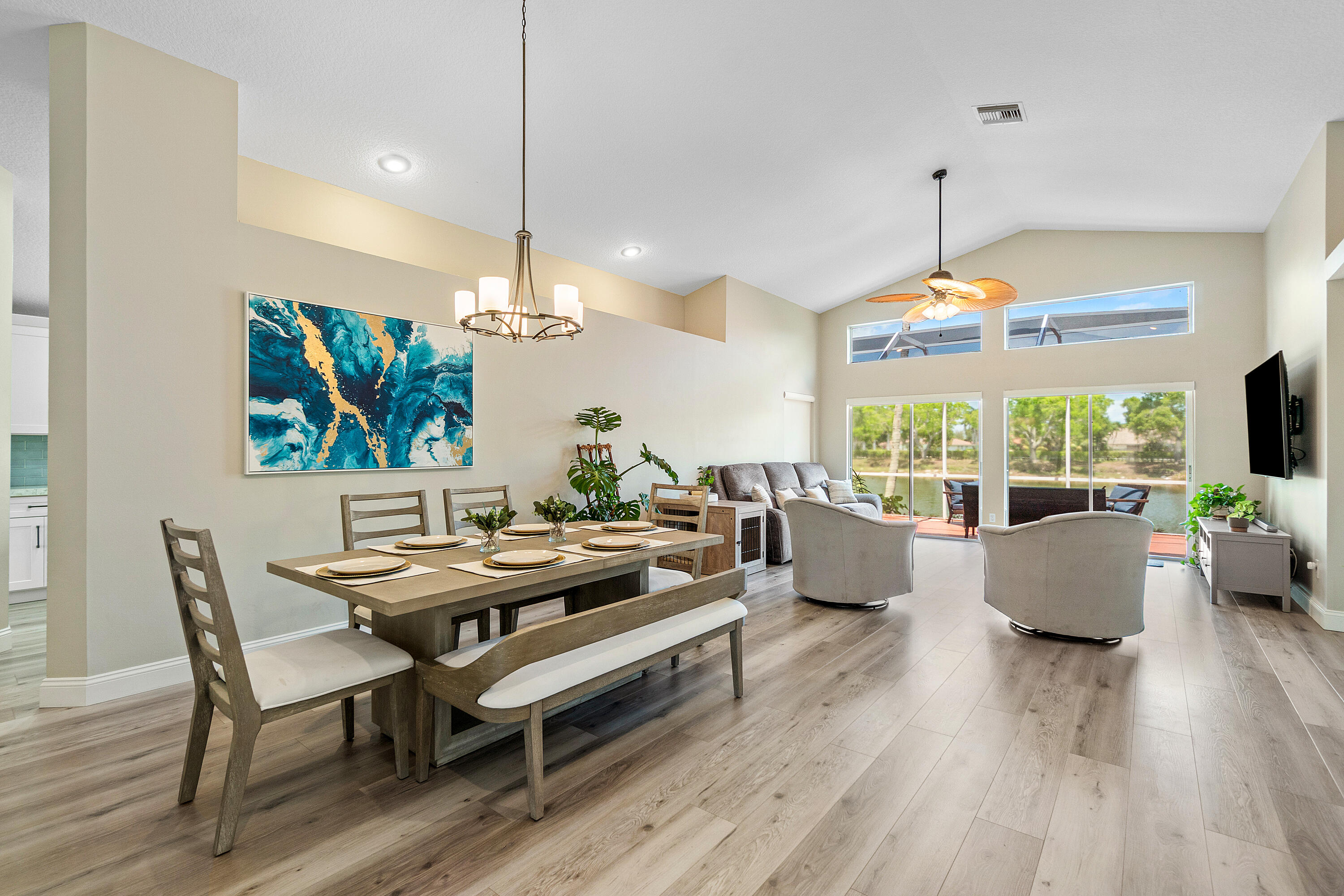 10560 Plainview Circle Boca Raton, FL 33498 - Photo 2 of 45 a dining room with furniture a chandelier and wooden floor