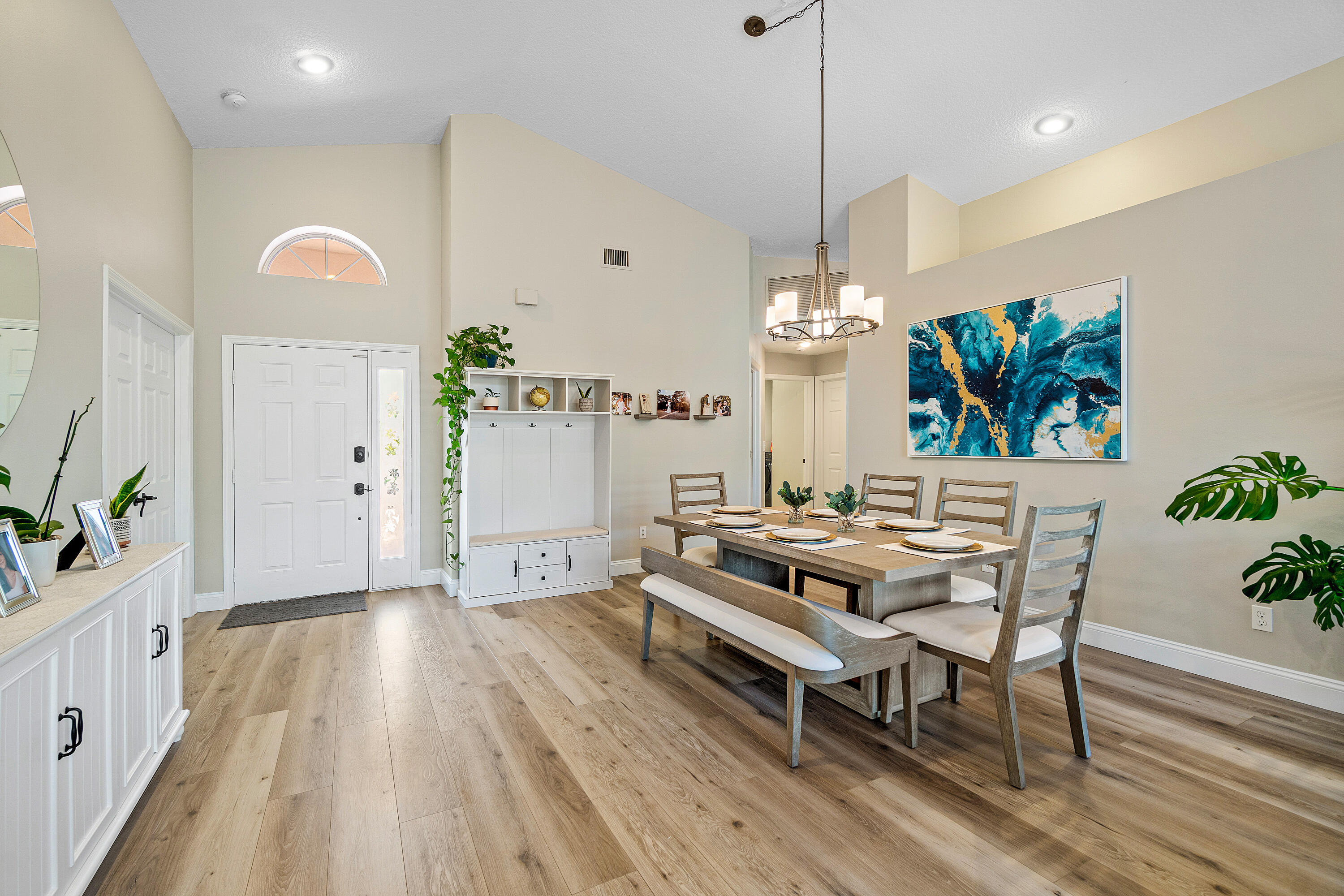 10560 Plainview Circle Boca Raton, FL 33498 - Photo 10 of 45 a living room with furniture a chandelier and wooden floor