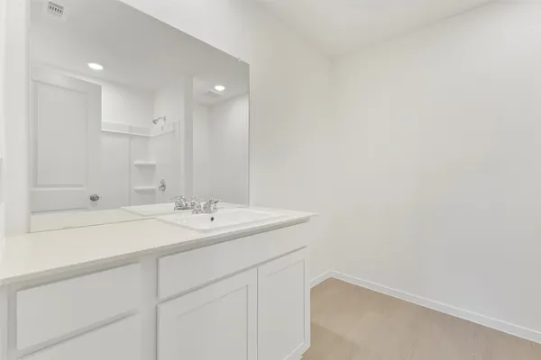 a bathroom with a sink a vanity and a mirror