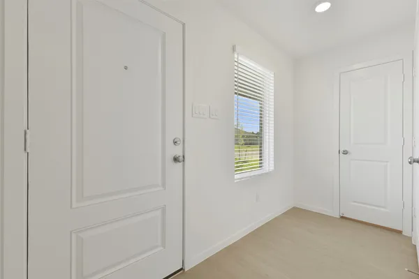 a view of an empty room with a window