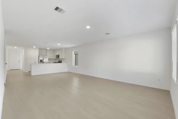 a view of a kitchen with white cabinets and sink