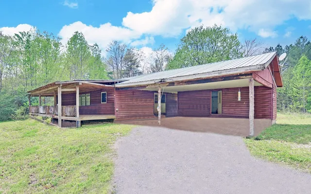 a large bedroom with wooden floor and large window