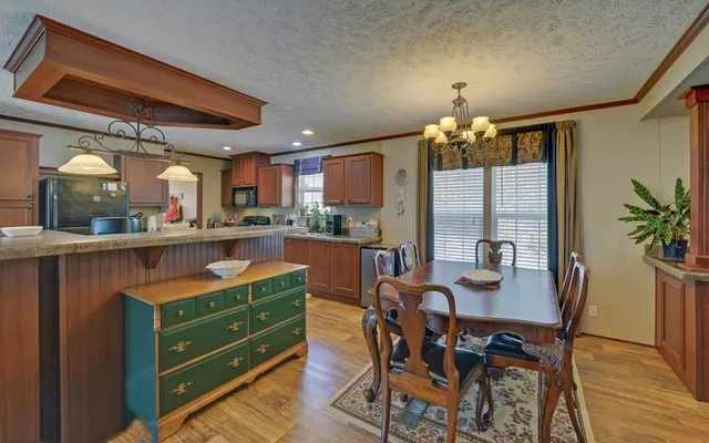a dining room with furniture and chandelier