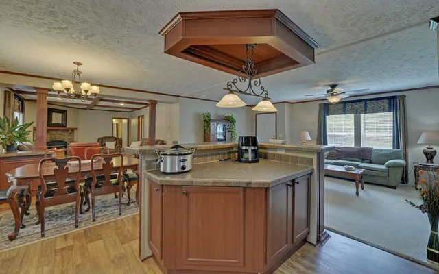a kitchen with stainless steel appliances kitchen island a table and chairs in it