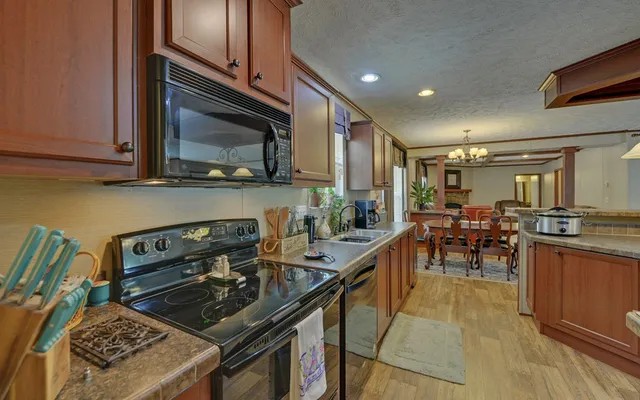 a kitchen with a stove a sink and a microwave