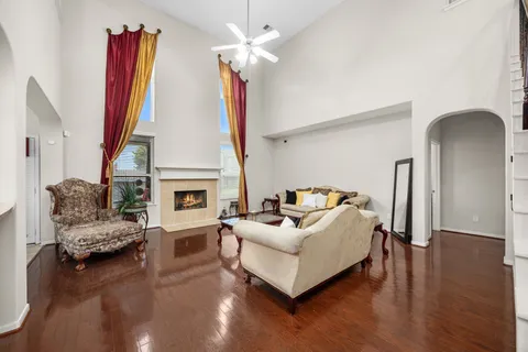 a living room with furniture a fireplace and a flat screen tv