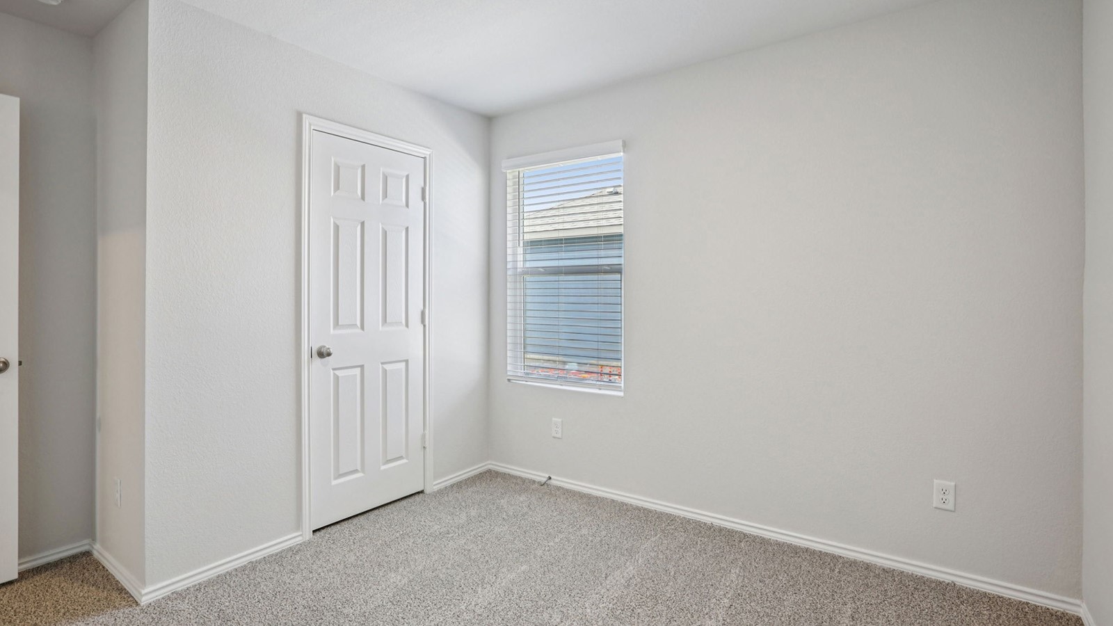 156 Wyatt Way Jarrell, TX 76537 - Photo 24 of 30 Room featuring light gray walls, gray carpeting, a window with blinds, and white trim