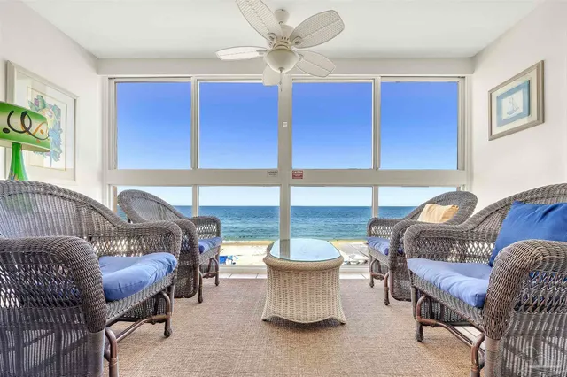 a living room with furniture a window and a chandelier