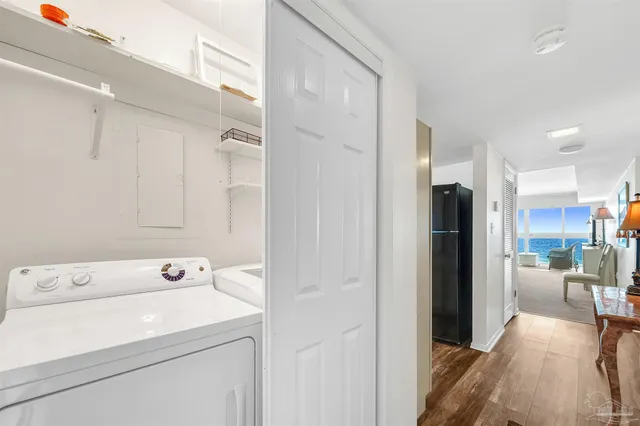 a view of washer and dryer with kitchen in the background