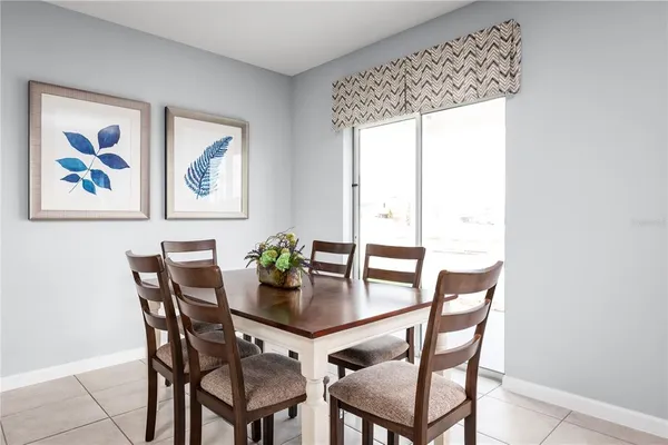 a dining room with furniture and window