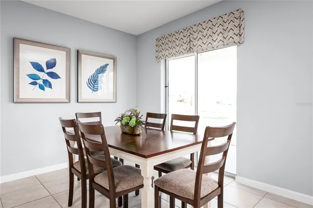 a dining room with furniture and window