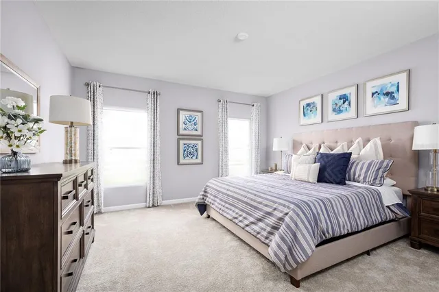 a bedroom with a bed flat screen tv and a window