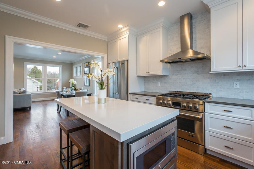 52 Brookside Drive, Unit D Greenwich, CT 06830 - Photo 11 of 24 a kitchen with a stove a sink and a refrigerator