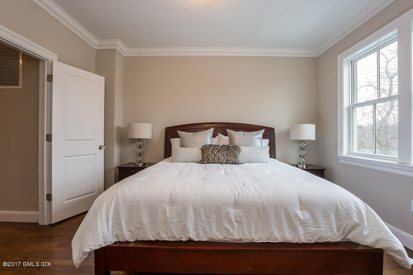 52 Brookside Drive, Unit D Greenwich, CT 06830 - Photo 20 of 24 a bedroom with a bed and window