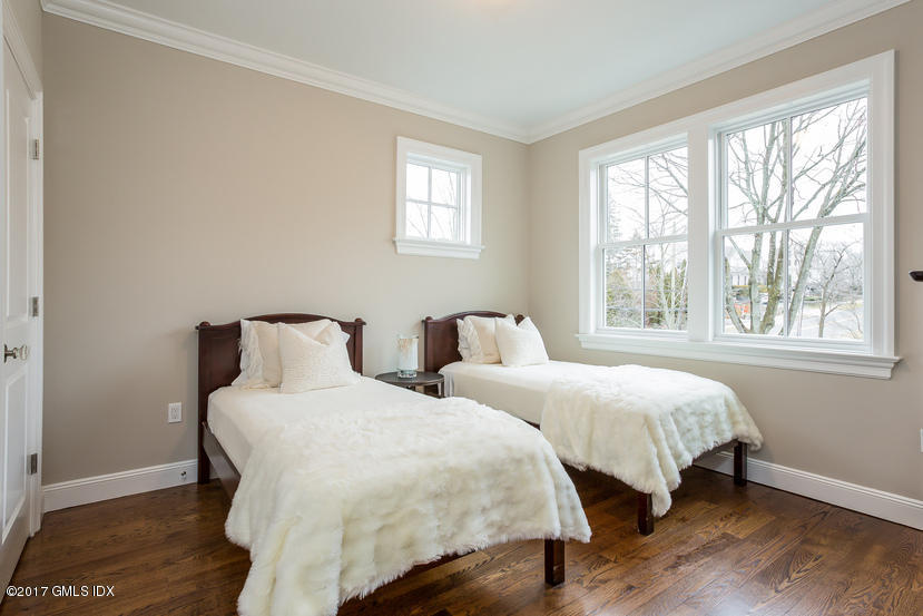 52 Brookside Drive, Unit D Greenwich, CT 06830 - Photo 23 of 24 a bedroom with two beds and a window