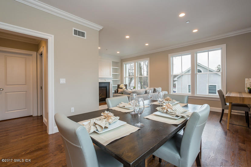 52 Brookside Drive, Unit D Greenwich, CT 06830 - Photo 8 of 24 a dining room with wooden floor a glass table and chairs