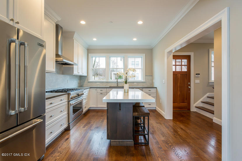 52 Brookside Drive, Unit D Greenwich, CT 06830 - Photo 9 of 24 a kitchen with a table chairs refrigerator and cabinets