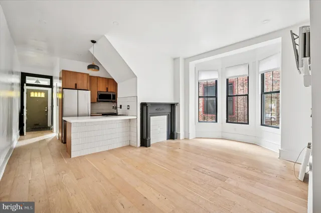 a kitchen with stainless steel appliances kitchen island wooden cabinets and granite counter tops