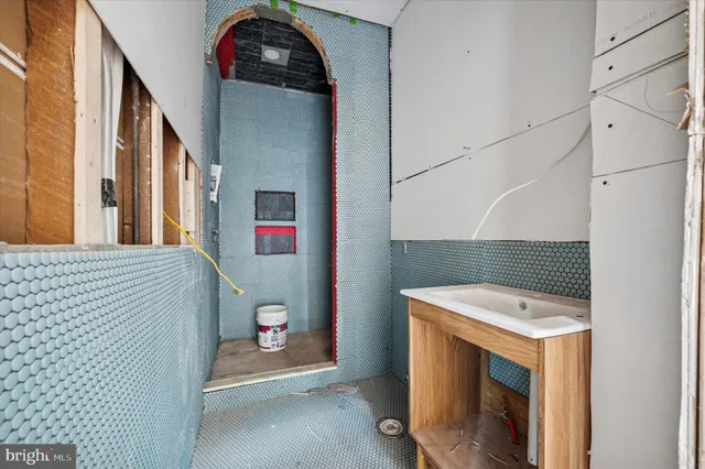a view of a patio with two couches and deck with wooden floor and fence